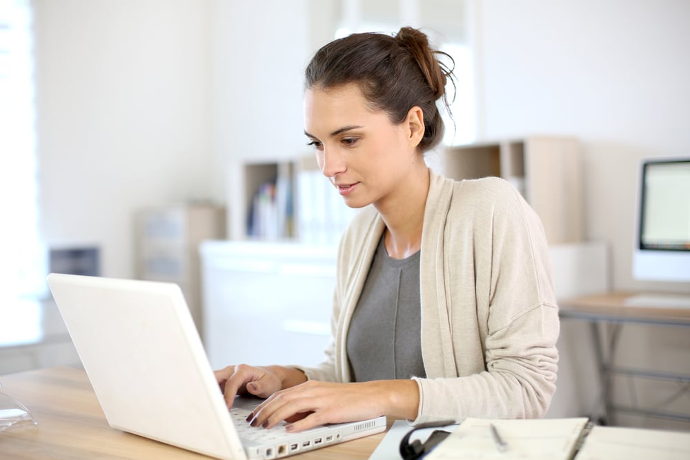 Attractive woman working in office on laptop-1
